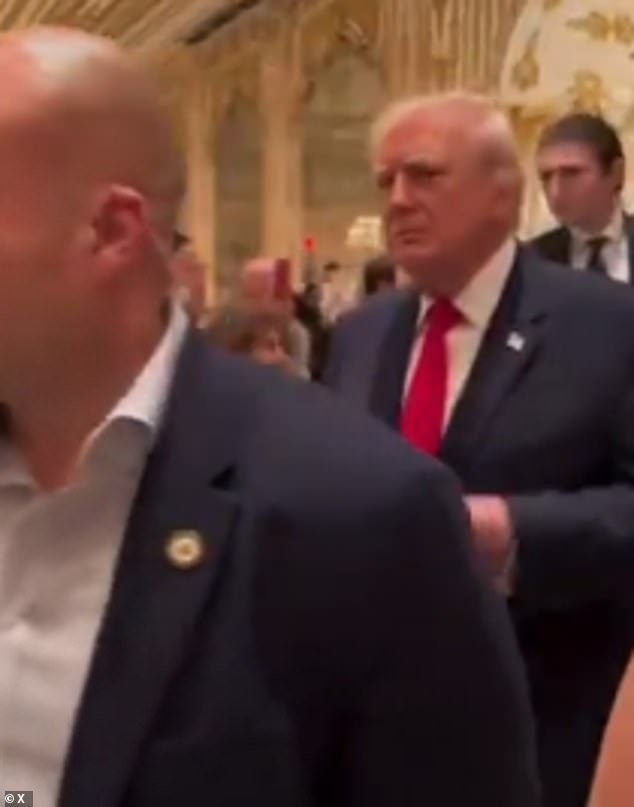 104278945-15335737-Barron_walks_behind_his_father_Donald_as_they_receive_a_standing-a-3_1764360545465.jpg