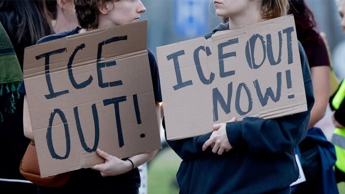 anti-ice-protesters-hold-signs.jpg